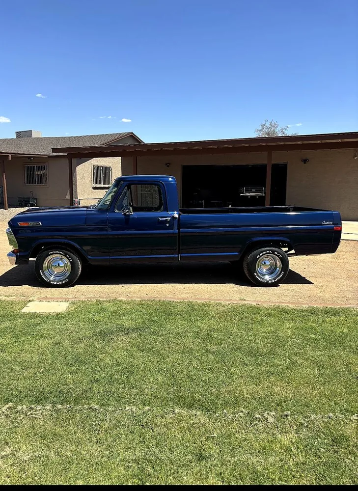 Restored classic Ford F-100 Custom pickup in deep blue
